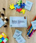 Luna & Eve multivitamin packages on a wooden surface with toys and stationery items.